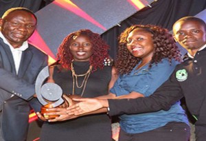 Cynthia Anyango receives Safaricom App Award from Bitange Ndemo in December last year (2)