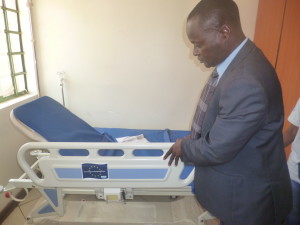 Dr.Juma Sindani Sub-County MOH looking at one of the donated beds, Korogocho Health Centre.