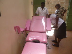 Nurses at Korogocho Health Centre trying to adjusting a delivery bed designed for women living with disability .