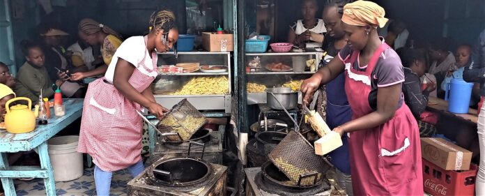 Wangare Maina (Left) in her chips eatery in Nakuru County. Photo Daniel Kipchumba.