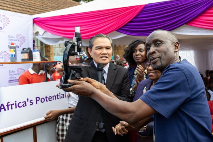 Malaysian Ambassador to Kenya Ruzaimi Mohamad, In a Blue Shirt Headteacher Kibera Samuel Onyango During the Event